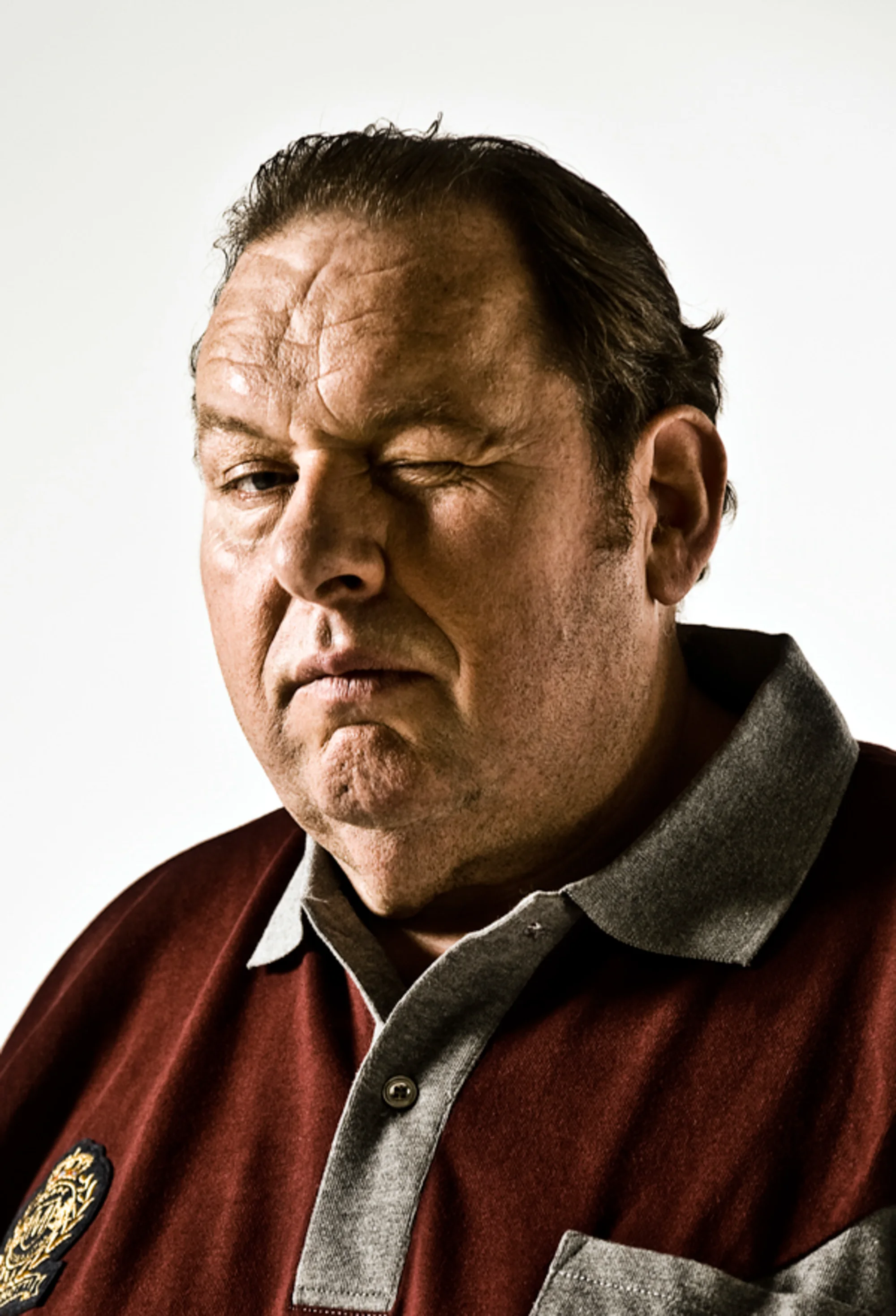 Close-up of Ottfried Fischer in a red and grey jacket — Ottfried Fischer, celebrity portrait photography by Janina Laszlo