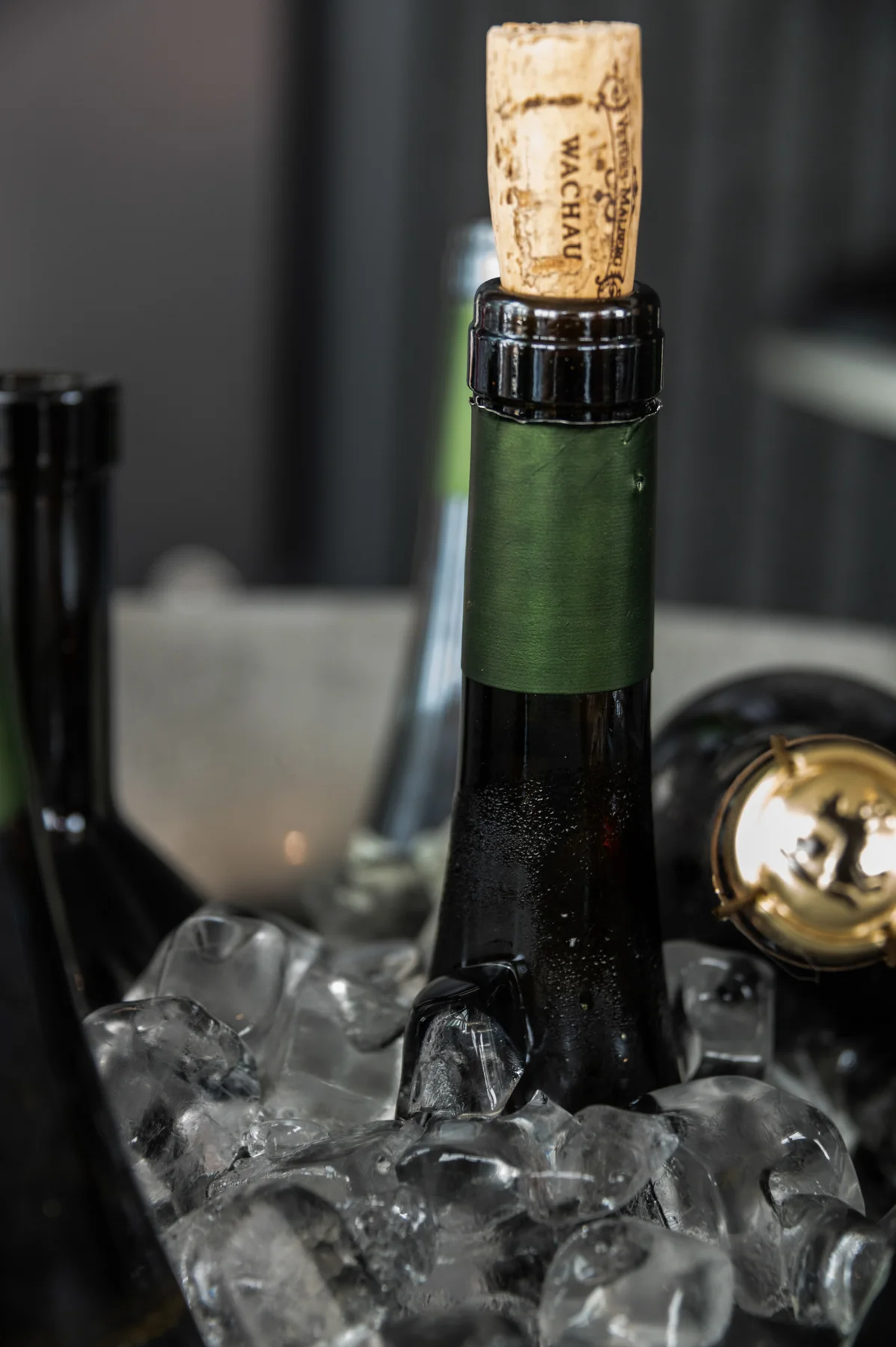 Wine bottle on a glass table — Salon Rouge, Michelin pop-up restaurant by Tohru Nakamura, Munich, for Der Feinschmecker — food and portrait photography by Janina Laszlo