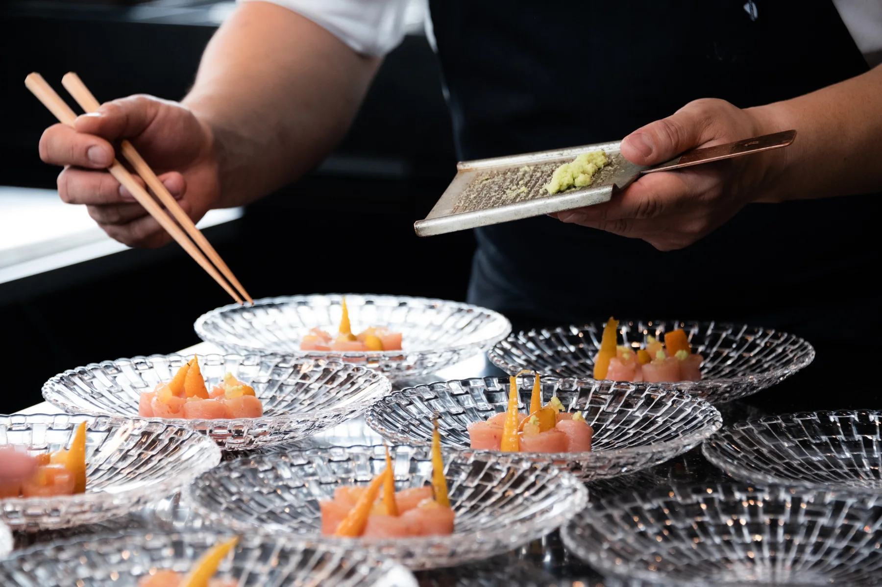 Hands plating a dish with chopsticks — Salon Rouge, Michelin pop-up restaurant by Tohru Nakamura, Munich, for Der Feinschmecker — food and portrait photography by Janina Laszlo