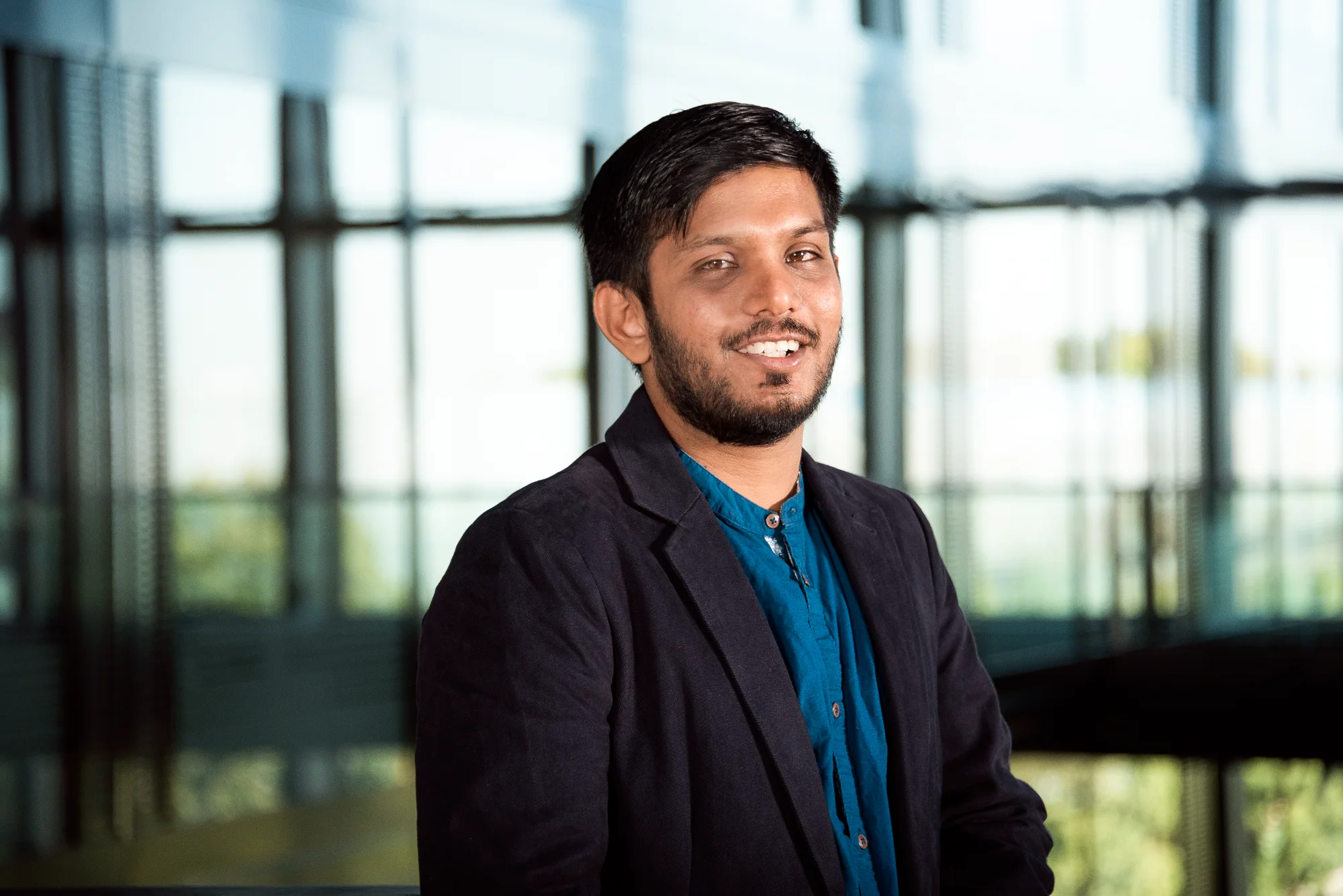 Bearded employee in a suit jacket in the office — SWMH, employer branding photography by Janina Laszlo
