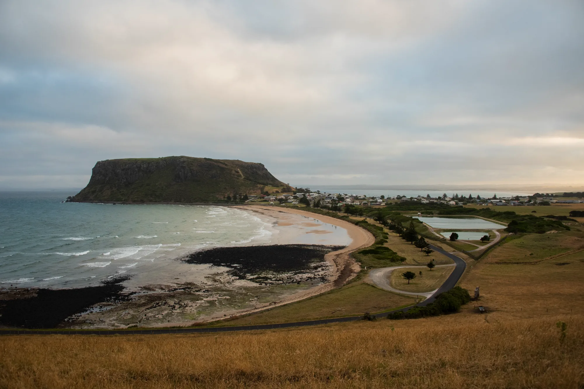 The Nut rising above the beach and village of Stanley — Tasmania, landscape and travel photography by Janina Laszlo