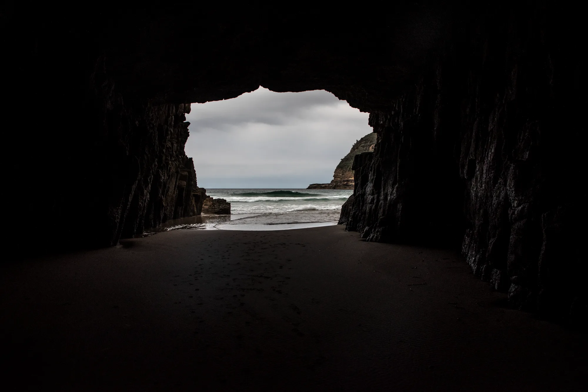 Ocean waves framed by the mouth of Remarkable Cave, Tasman Peninsula — Tasmania, landscape and travel photography by Janina Laszlo