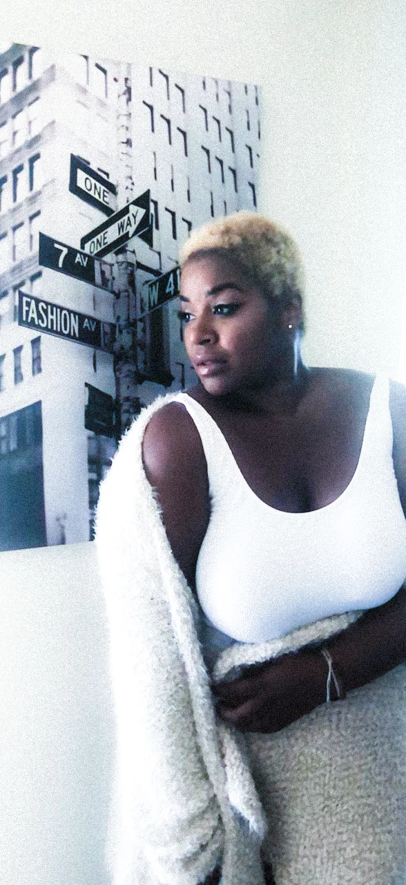 Lola with platinum hair in a white top against a New York street sign print, Miami — Deutsche Telekom FaceTime Session, commercial and lifestyle photography by Janina Laszlo