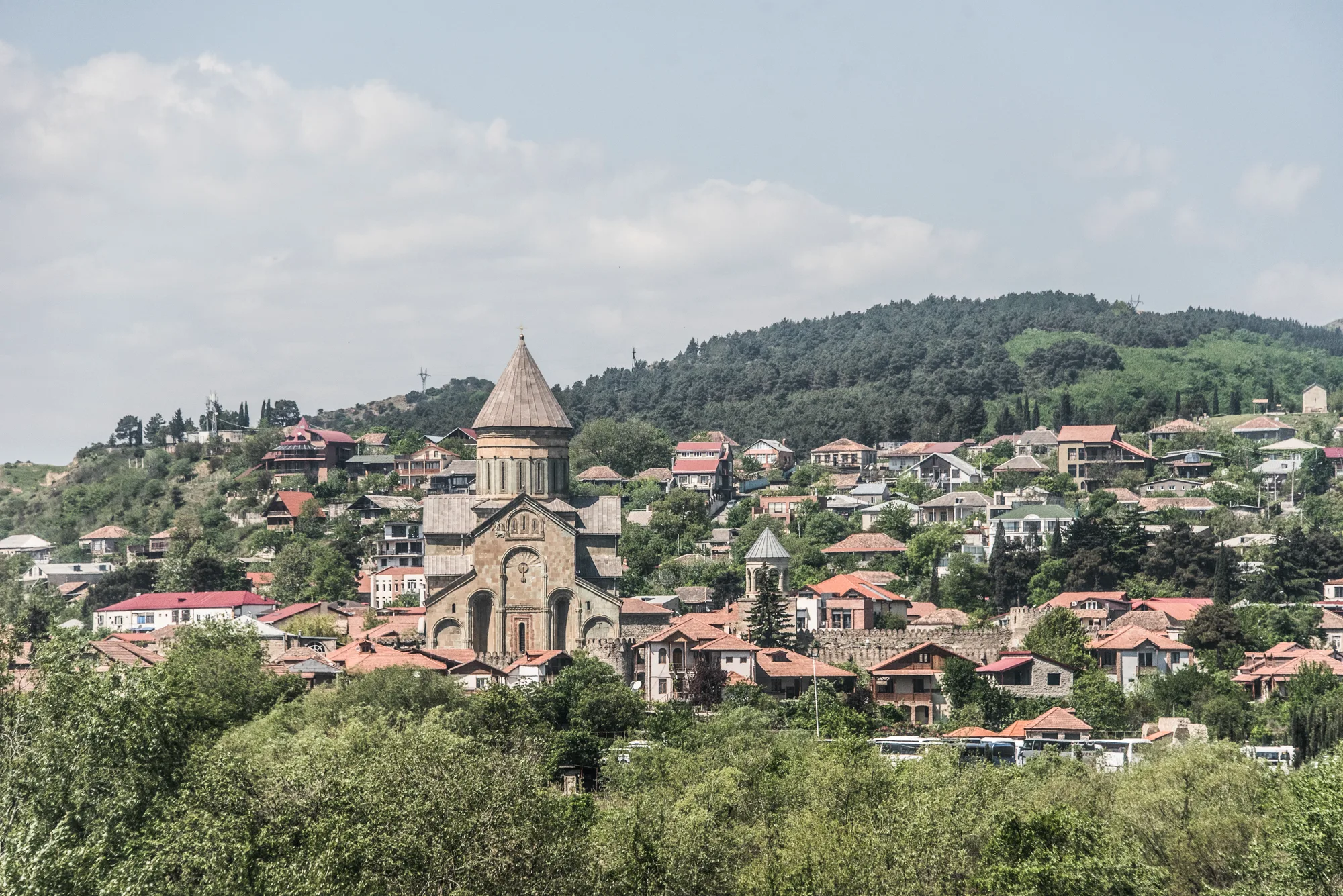 Svetitskhoveli Cathedral rising above the rooftops of Mtskheta, Georgia — Travel Notes, travel photography by Janina Laszlo