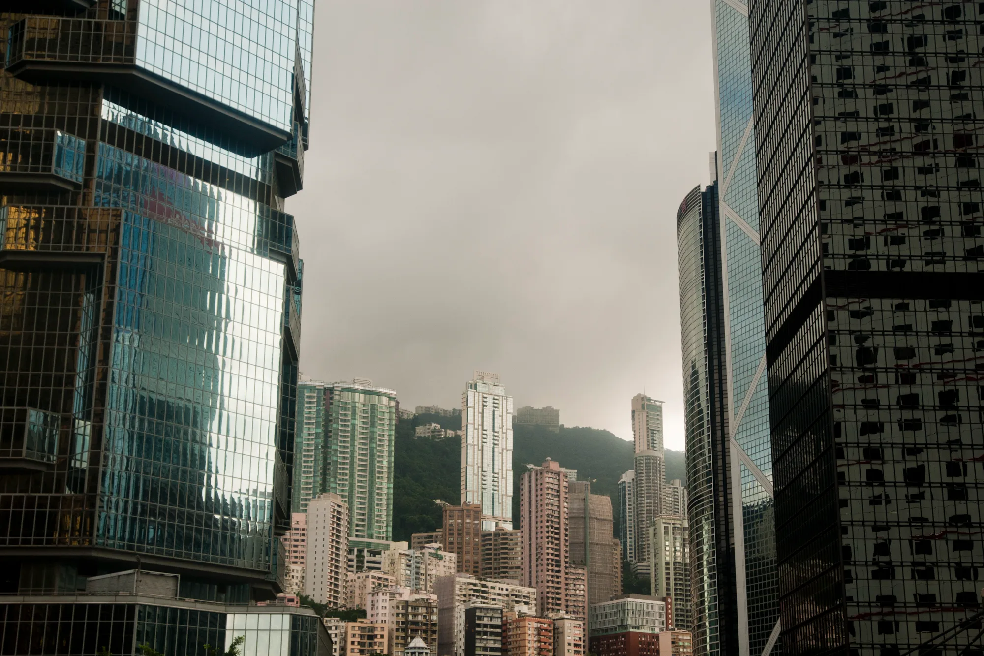 Glass skyscrapers of Central framing hillside towers and Victoria Peak in cloud, Hong Kong — Travel Notes, travel photography by Janina Laszlo