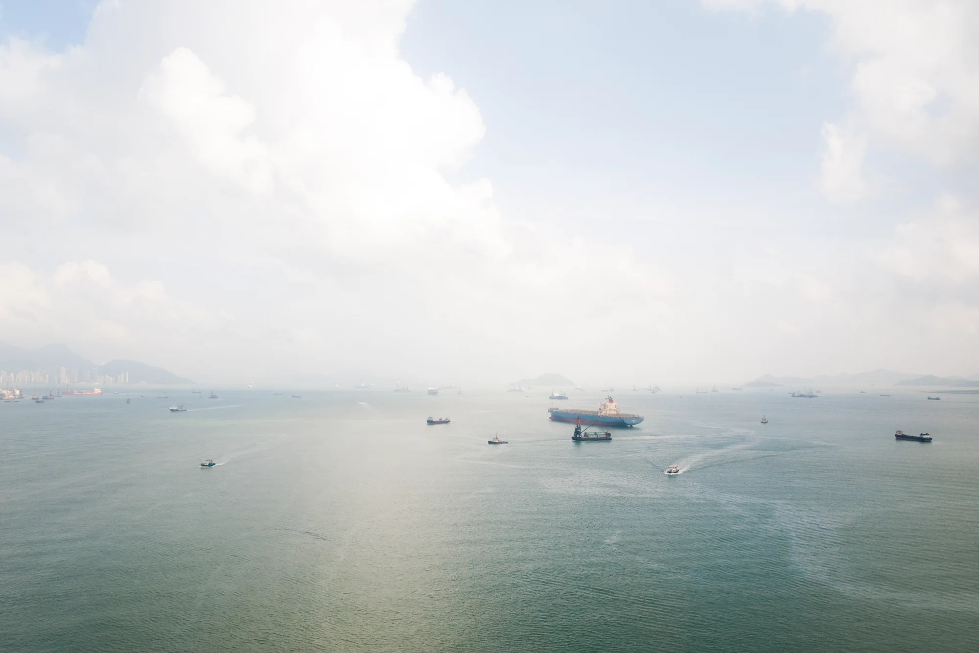Container ship and boats in the hazy waters of Victoria Harbour, Hong Kong — Travel Notes, travel photography by Janina Laszlo