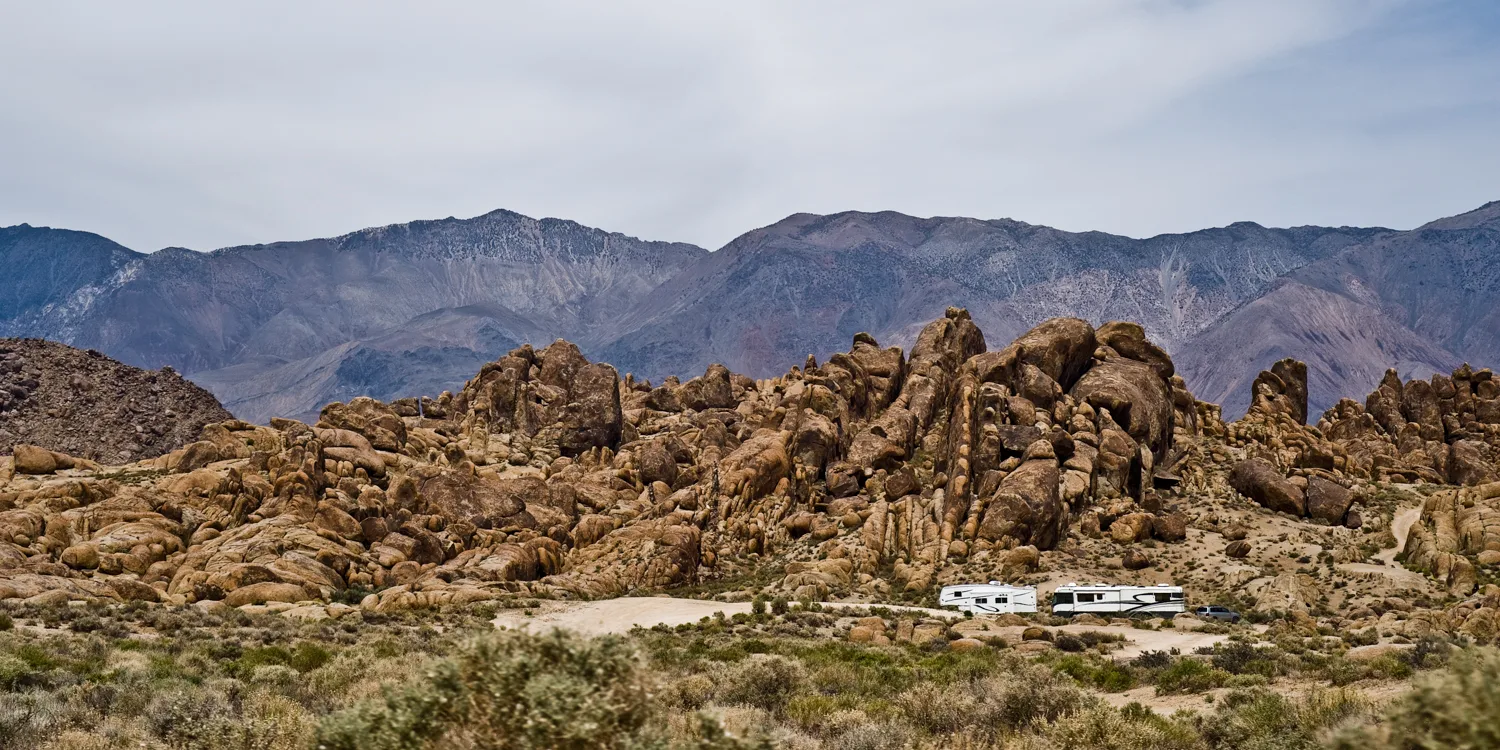 Granite boulders of the Alabama Hills with RVs below the Sierra Nevada, Lone Pine, California — US West Coast, panoramic fine art landscape photography by Janina Laszlo