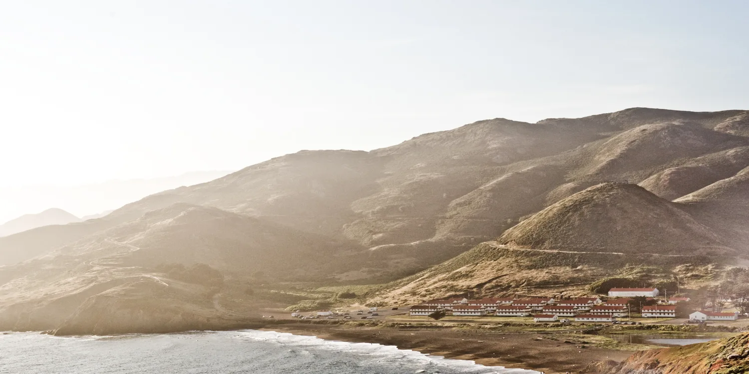 Fort Cronkhite barracks above Rodeo Beach in hazy evening light, Marin Headlands, California — US West Coast, panoramic fine art landscape photography by Janina Laszlo