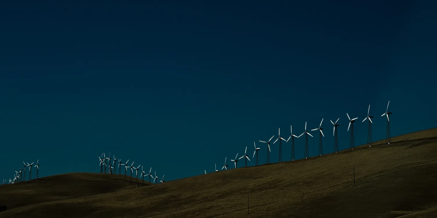 Wind turbines along a golden ridge under a deep blue sky, Altamont Pass, California — US West Coast, panoramic fine art landscape photography by Janina Laszlo