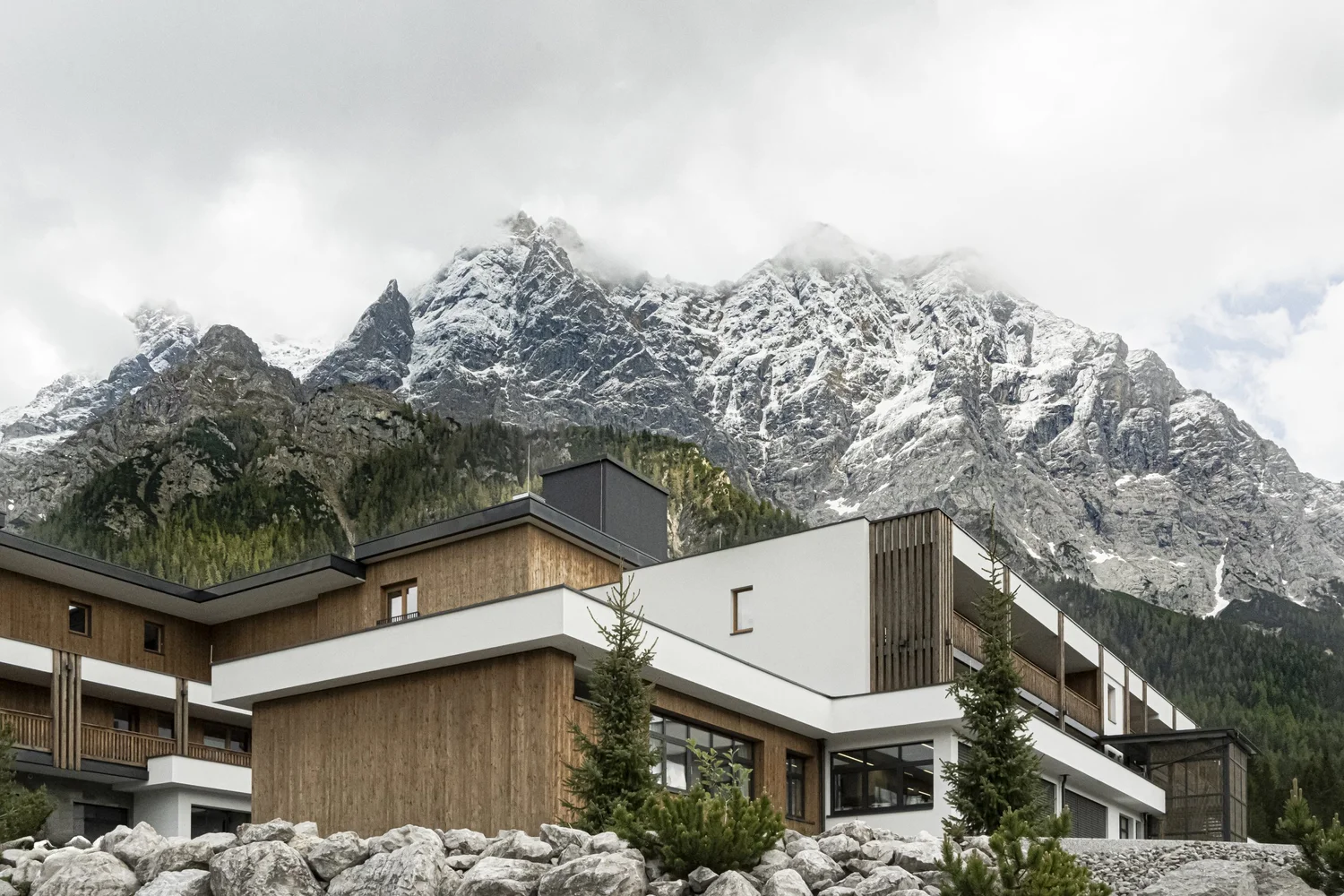 Zugspitz Resort hotel building at the foot of snowy mountains in Ehrwald, Tyrol — campaign photography by Janina Laszlo, Munich