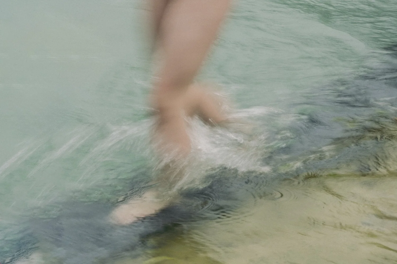 Bare feet stepping into clear mountain water, wellness mood at Zugspitz Resort — campaign photography by Janina Laszlo, Munich