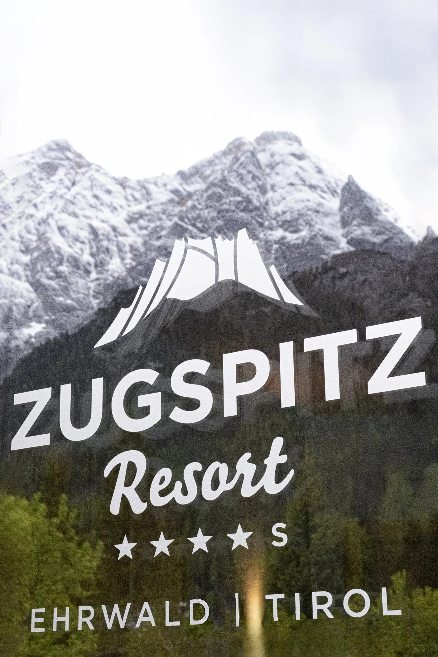 Zugspitz Resort four-star sign with mountain logo, Ehrwald, Tirol — campaign photography by Janina Laszlo, Munich