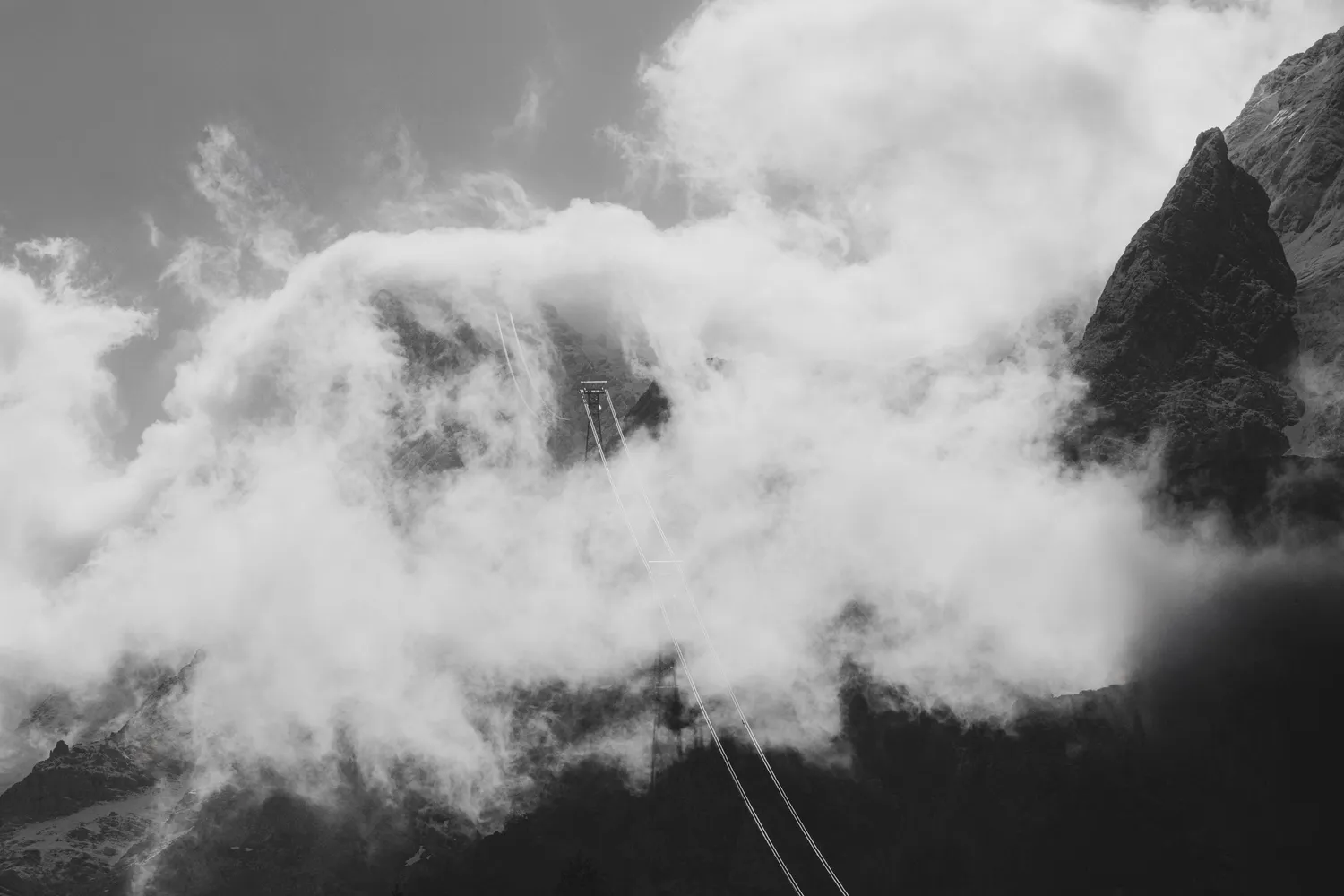 Black-and-white clouds drifting across a mountain flank, Zugspitz Resort, Ehrwald — campaign photography by Janina Laszlo, Munich
