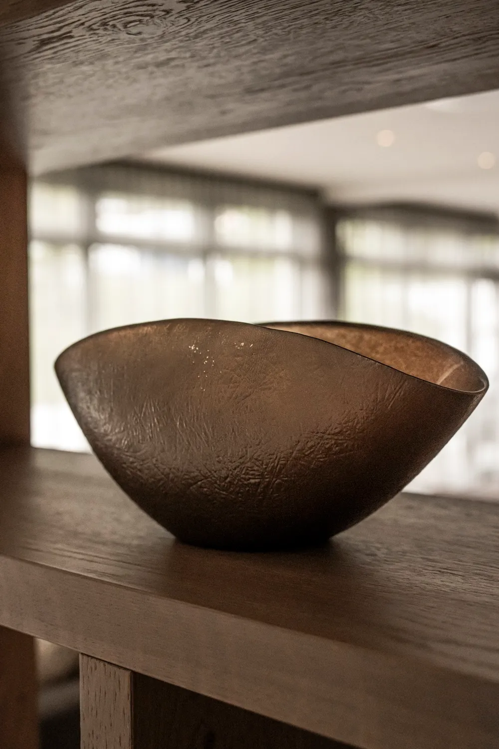 Ceramic bowl on a wooden shelf in the hotel lobby, Zugspitz Resort, Ehrwald — campaign photography by Janina Laszlo, Munich