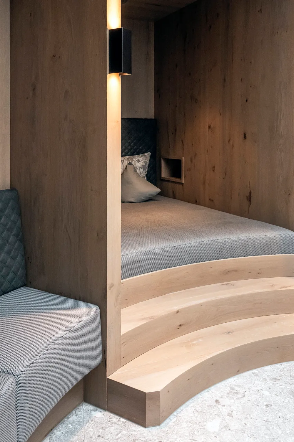 Wooden alcove bed with patterned cushions in a suite, Zugspitz Resort, Ehrwald — campaign photography by Janina Laszlo, Munich