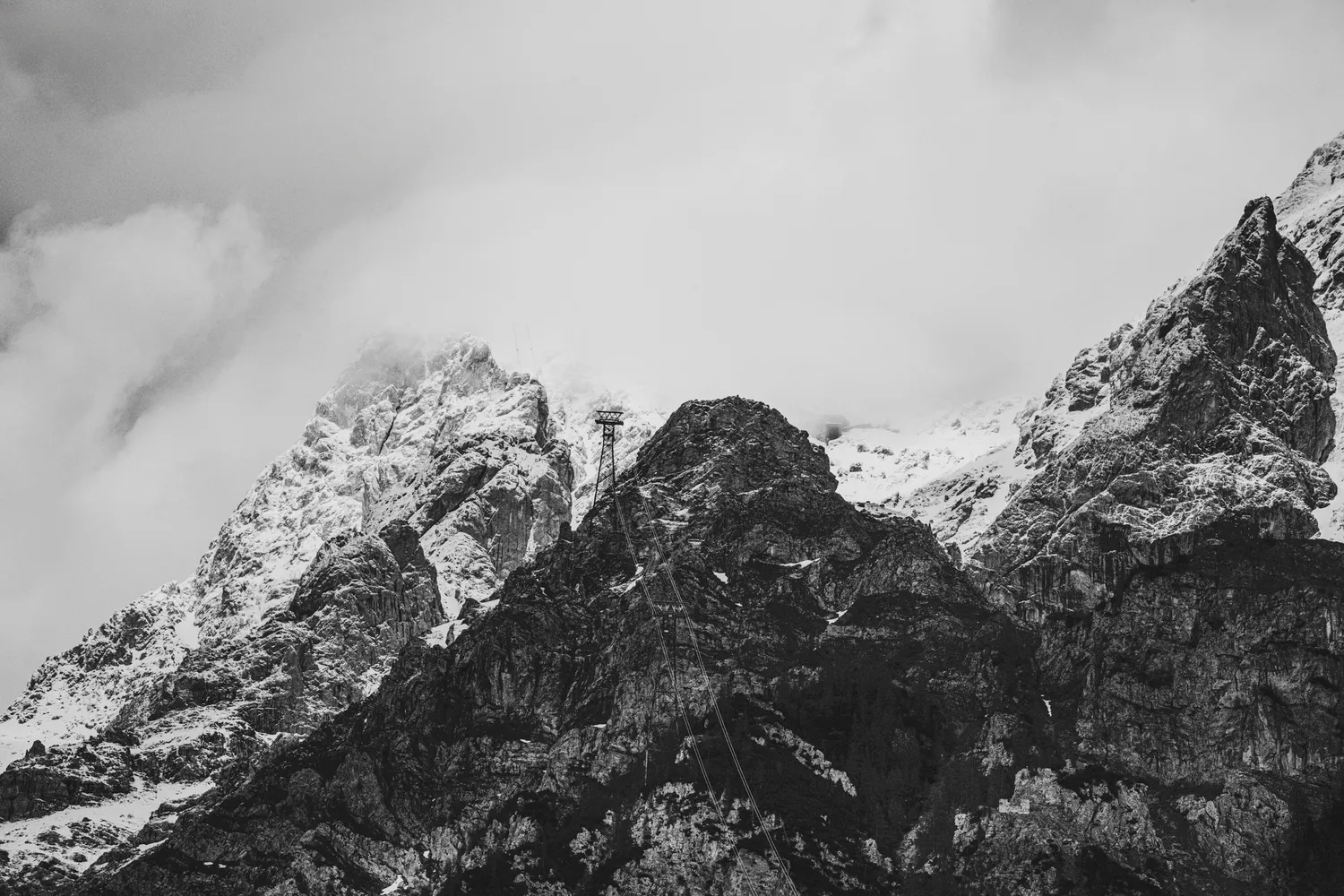 Black-and-white snowy mountain peaks under clouds, Zugspitz Resort, Ehrwald — campaign photography by Janina Laszlo, Munich