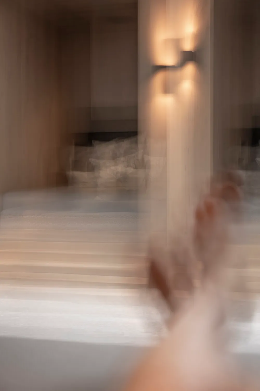 Motion-blurred hand in a softly lit hotel corridor, Zugspitz Resort, Ehrwald — campaign photography by Janina Laszlo, Munich