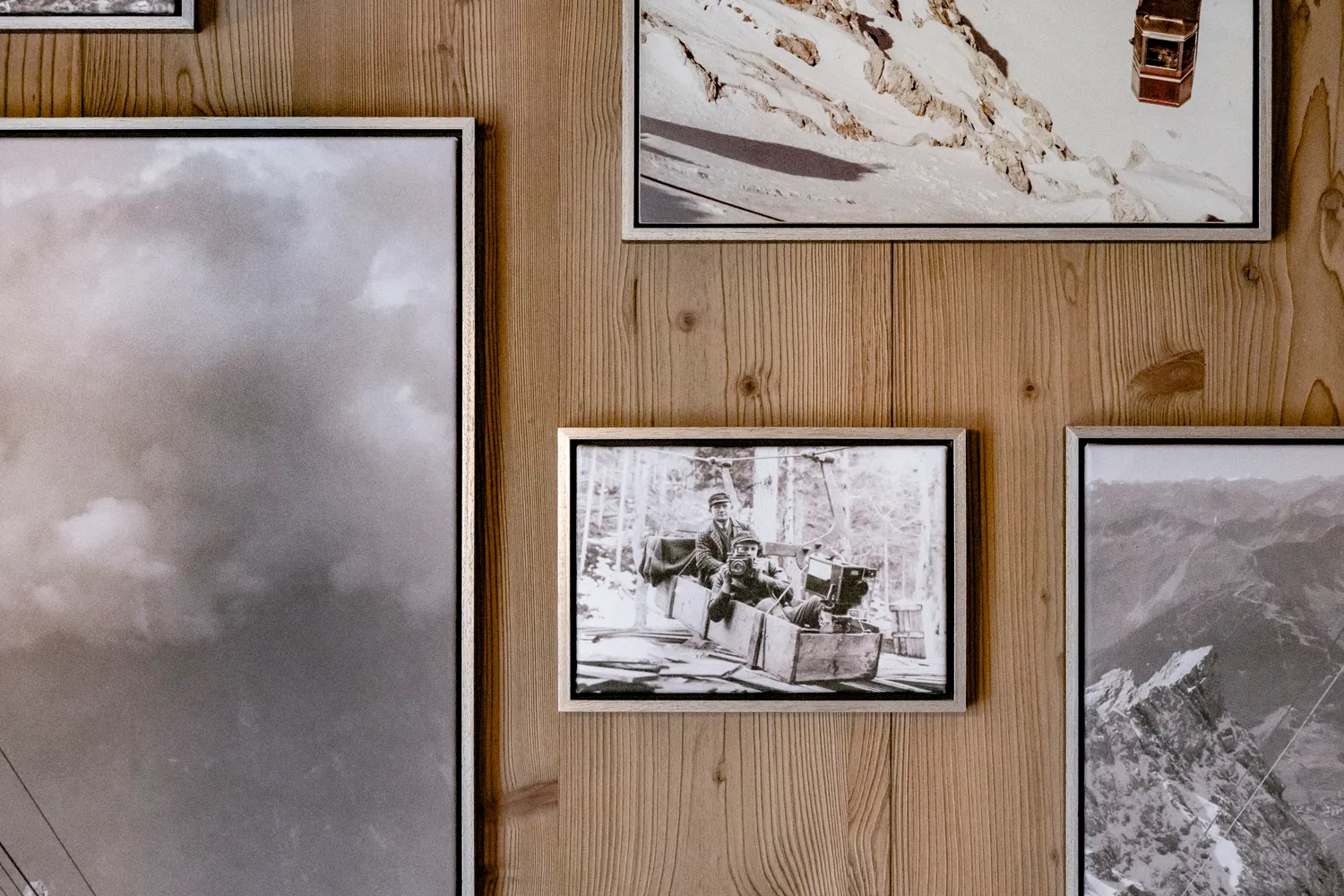 Wood-panelled wall with framed mountain photographs, Zugspitz Resort, Ehrwald — campaign photography by Janina Laszlo, Munich